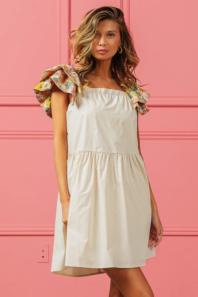 Model wearing The Everly Embroidered Bloom Dress with floral print sleeves and delicate flower embroidery, styled for spring.