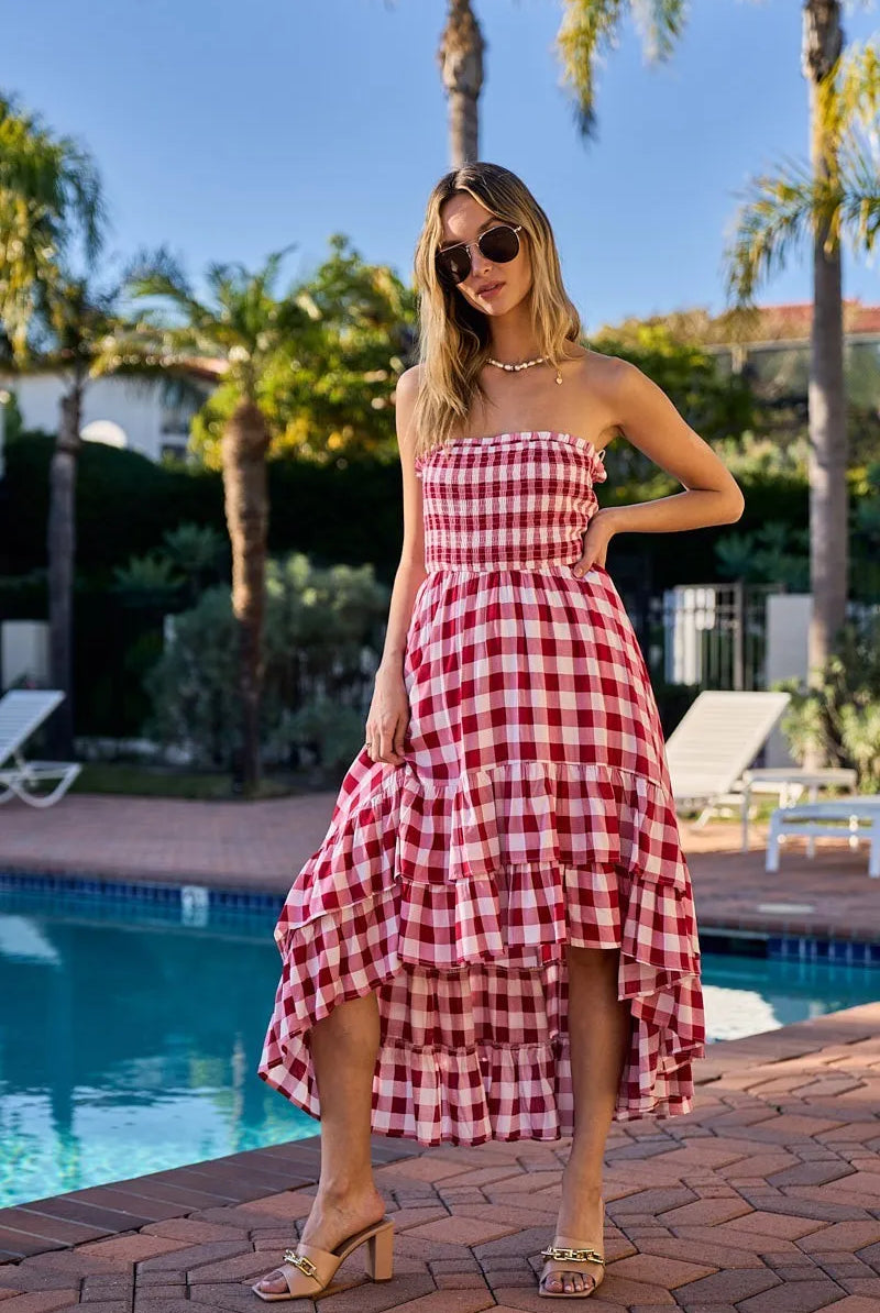 Woman wearing an off-shoulder gingham smocked dress with a flowy silhouette, perfect for casual summer outings, brunch, or vacation wear