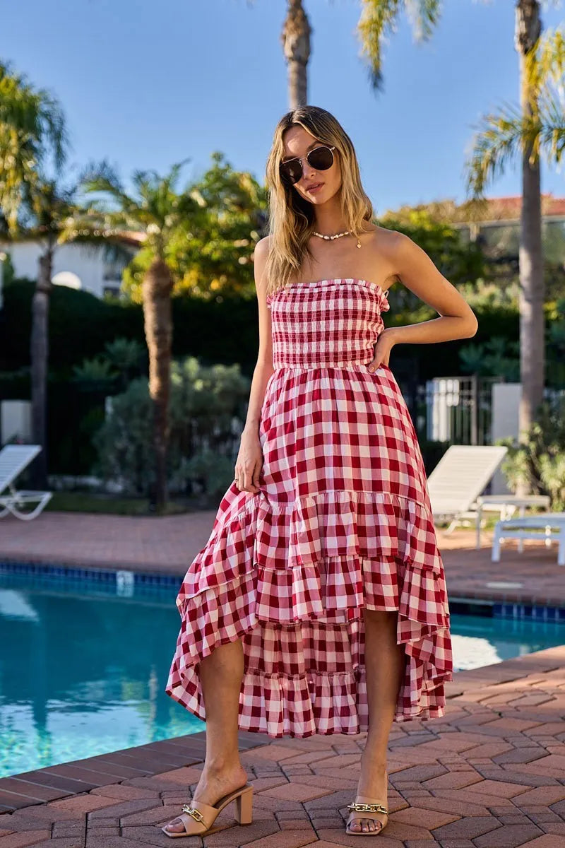Woman wearing an off-shoulder gingham smocked dress with a flowy silhouette, perfect for casual summer outings, brunch, or vacation wear