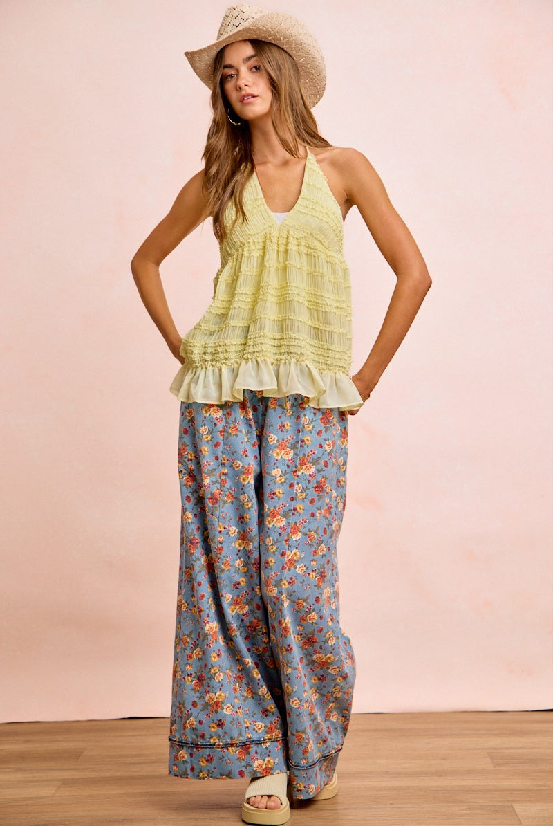 Bloom & Flow wide leg pants in dusty blue with vibrant floral print, featuring drawstring waist and side pockets