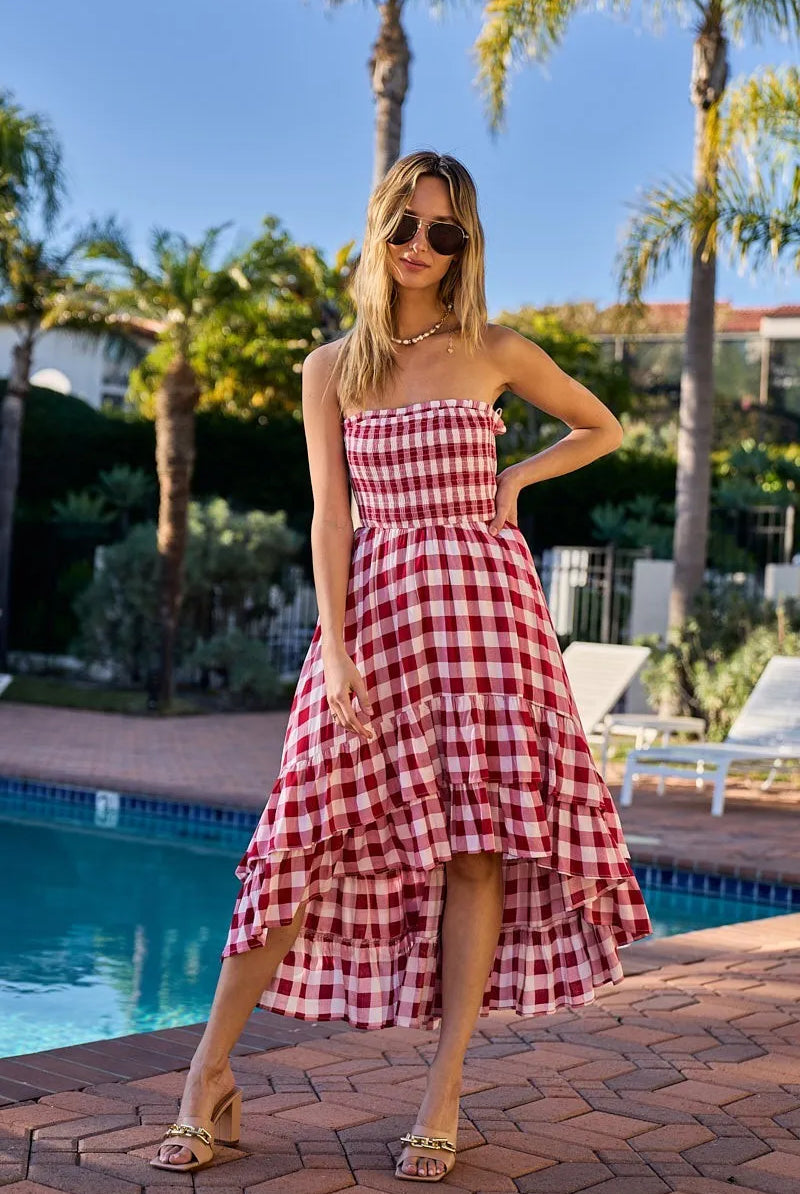 Woman wearing an off-shoulder gingham smocked dress with a flowy silhouette, perfect for casual summer outings, brunch, or vacation wear