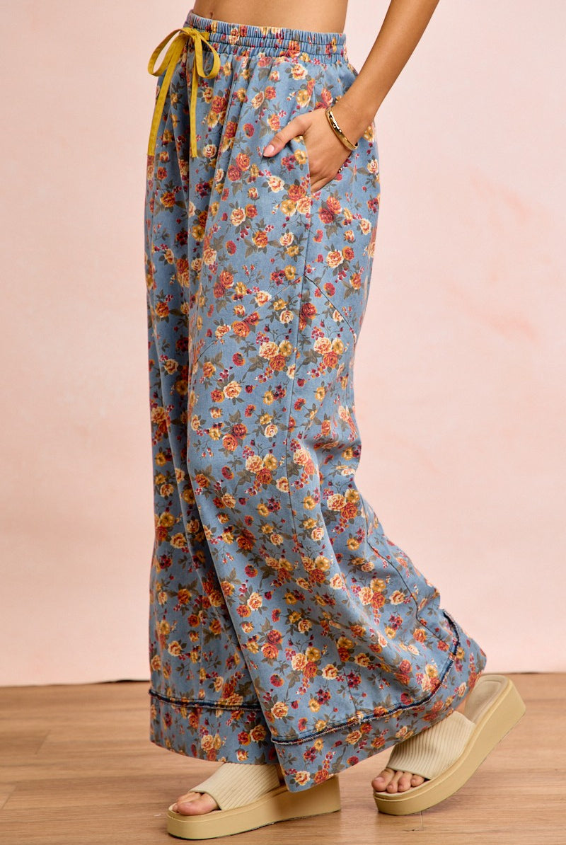 Side view of floral wide leg pants showing flowing silhouette and relaxed fit on model