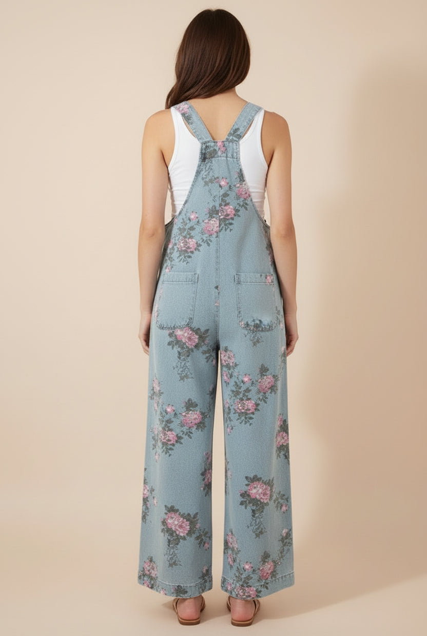 Vintage-inspired floral denim overalls at Thread Bar Boutique with pleated waist and feminine pink and sage print.