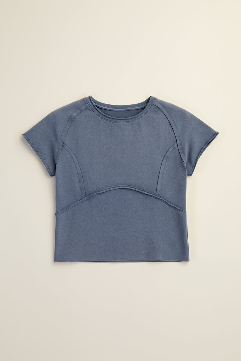 Close-up of curved seam detailing with raw edges on mineral washed tee