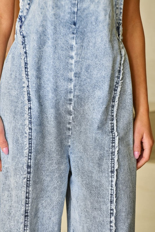 Thread Bar Boutique relaxed fit denim overalls with wide legs, functional pockets, and vintage light wash for year-round styling. fabric close up