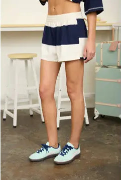 Sporty rugby stripe matching set featuring a relaxed oversized fit, soft knit fabric, and coordinating shorts. Chic women's athleisure outfit perfect for game days, weekend outings, and laid-back fashion.