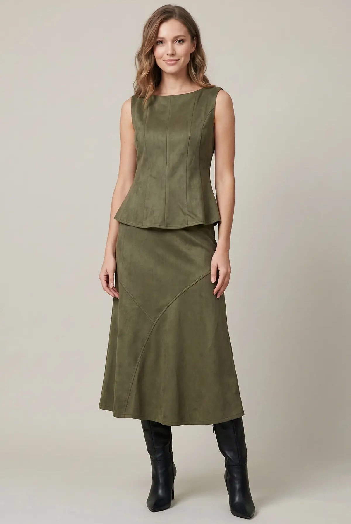 Women's structured suede-feel peplum top styled for a night out with a sophisticated fitted silhouette and boat neckline