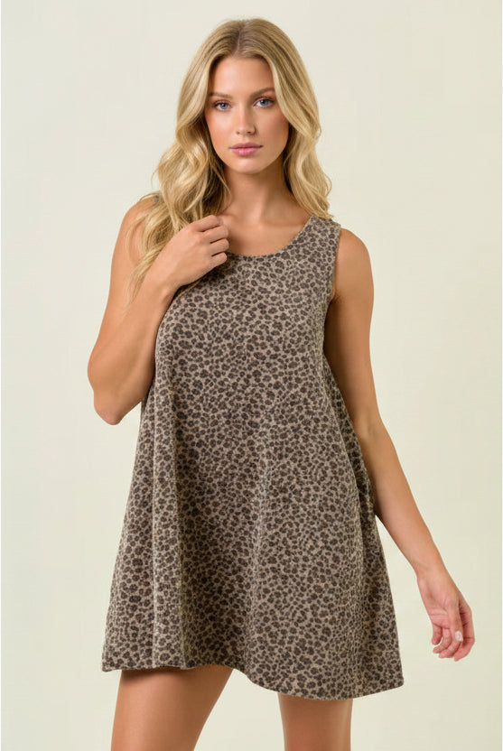 Fashionable leopard print mini dress for women with a relaxed silhouette, sleeveless cut, hidden pocket, and lightweight cotton fabric.