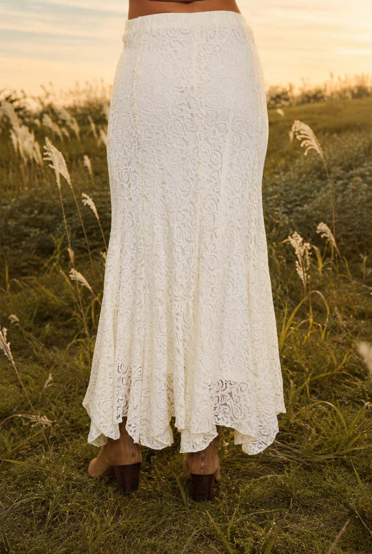 Cream lace godet midi skirt from Thread Bar Boutique featuring an elastic waistband, fully lined construction, and elegant movement. Timeless boutique skirt perfect for weddings, brunch dates, and dressy casual outfits.