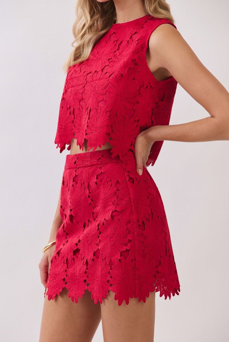 Floral lace crop top paired with matching high-rise mini skirt featuring intricate cutout detailing and scalloped hems