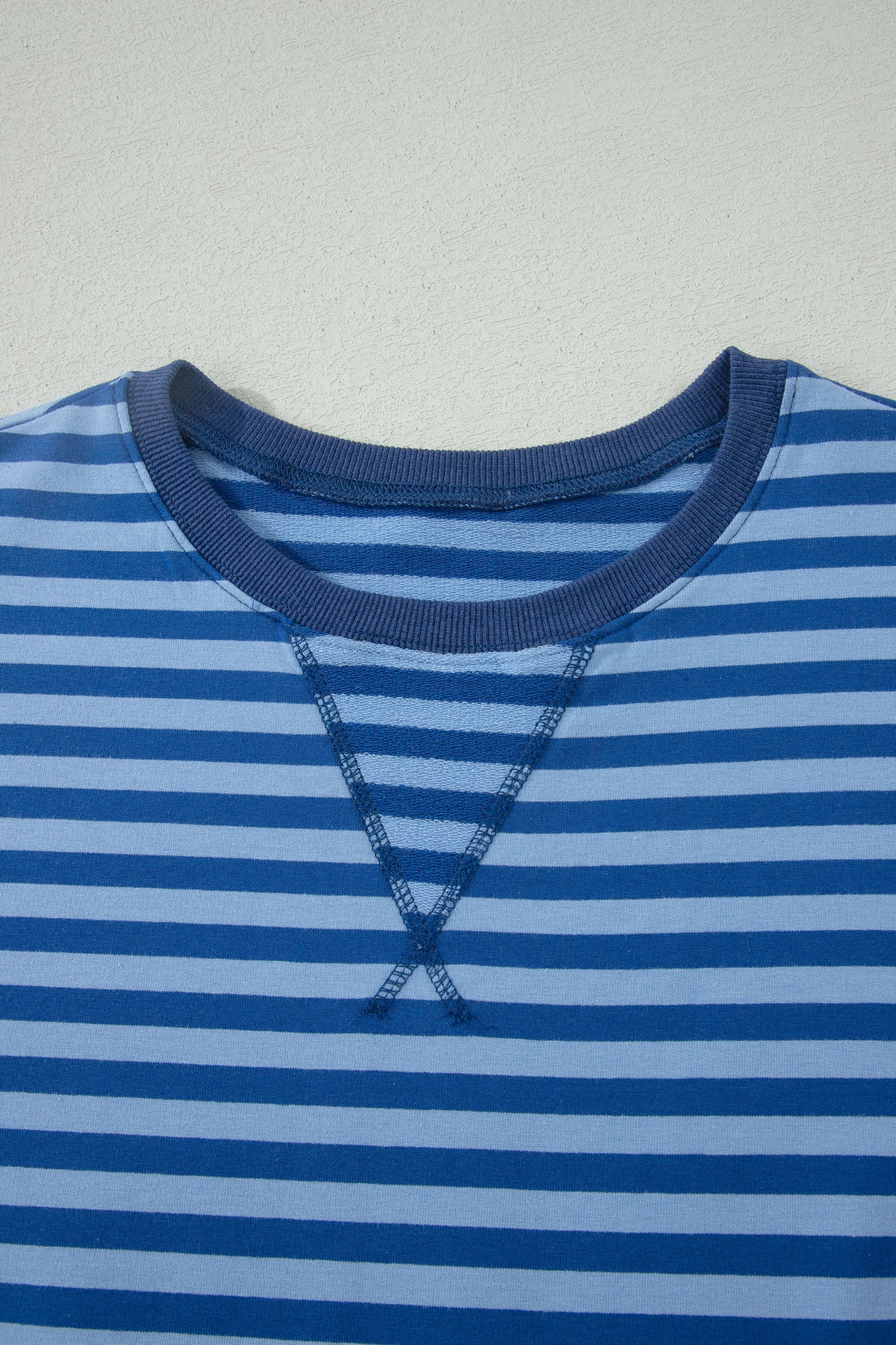 Close-up of a blue striped shirt with a plain background