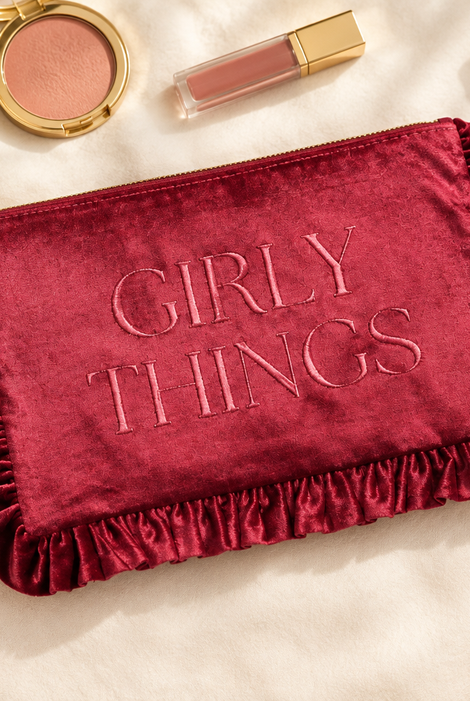 Thread Bar Boutique pink velvet toiletry bag with embroidered design, feminine ruffle edge, zip-top closure, and roomy interior for skincare, makeup, hair accessories, and travel essentials