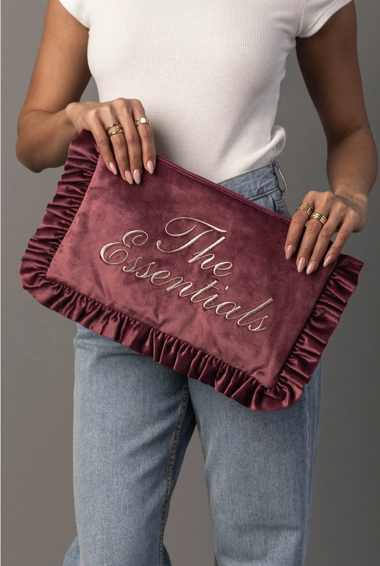 Thread Bar Boutique feminine pink velvet travel organizer with ruffle trim and embroidered “The Essentials” or “Girly Things” design, perfect for makeup, toiletries, chargers, and weekend getaways