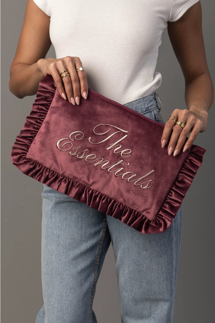 Thread Bar Boutique feminine pink velvet travel organizer with ruffle trim and embroidered “The Essentials” or “Girly Things” design, perfect for makeup, toiletries, chargers, and weekend getaways