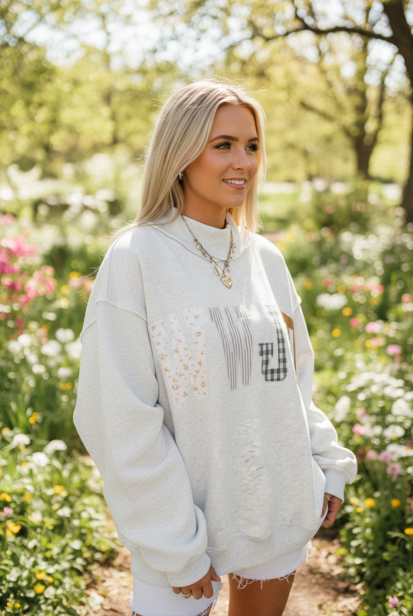 Women's WWJD Christian sweatshirt styled for a casual everyday outfit, featuring a relaxed mock neck silhouette, long sleeves, embroidered graphic detail, and comfortable midweight fabric.