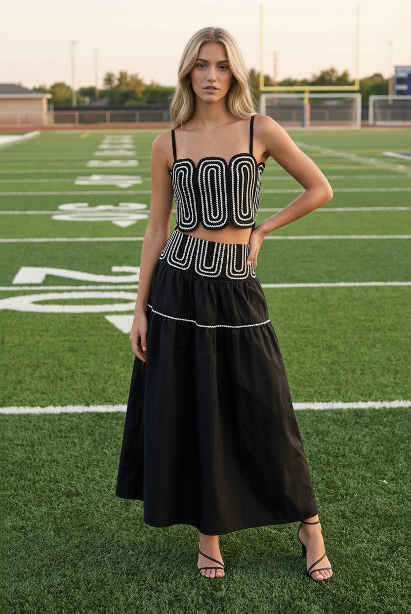 Fashion-forward black coordinated two-piece set featuring a fitted lace trim top and elegant flowy maxi skirt with invisible zipper closure. Lightweight lined boutique outfit ideal for game day fashion, brunch dates, country concerts, vacations, and seasonal events.