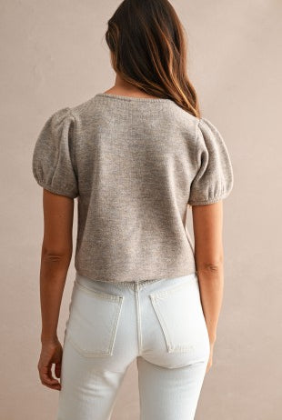 Women's button front knit top with a full-length button placket, crew neckline, feminine puff short sleeves, and relaxed silhouette for versatile styling.