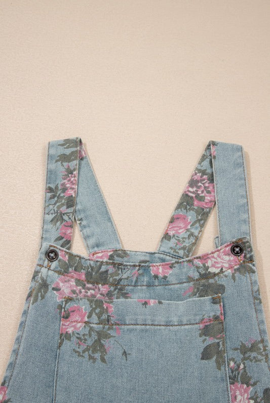 Pink and sage floral print denim overalls from Thread Bar Boutique with pleated detailing and relaxed wide leg silhouette.