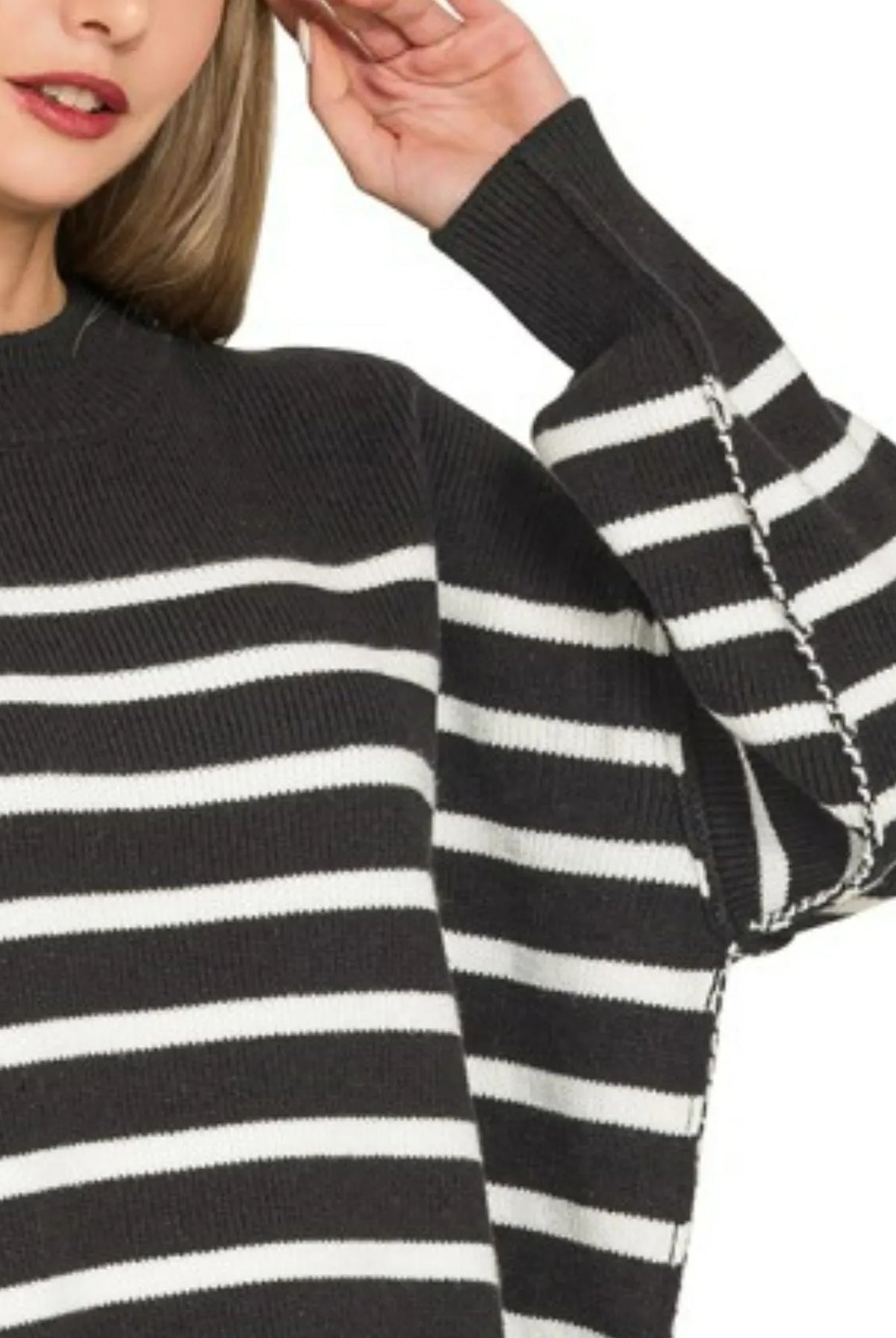 Upper body crop of Zenana Exposed Seam Striped Oversized Sweater — crew neckline, black and white stripe pattern, drop-shoulder silhouette