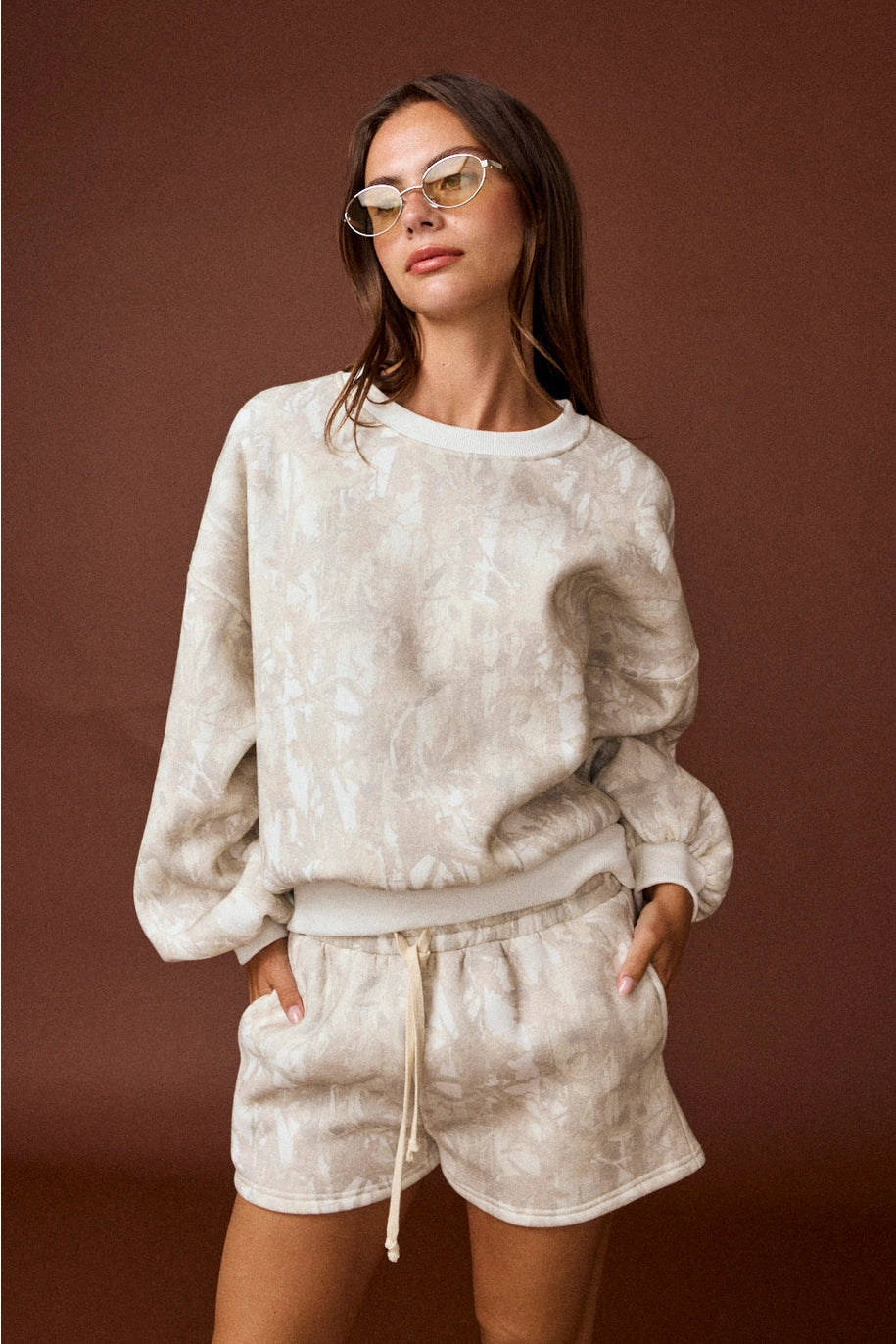 Woodland camo oversized crewneck sweatshirt, part of a matching camo sweat set with coordinating shorts.”