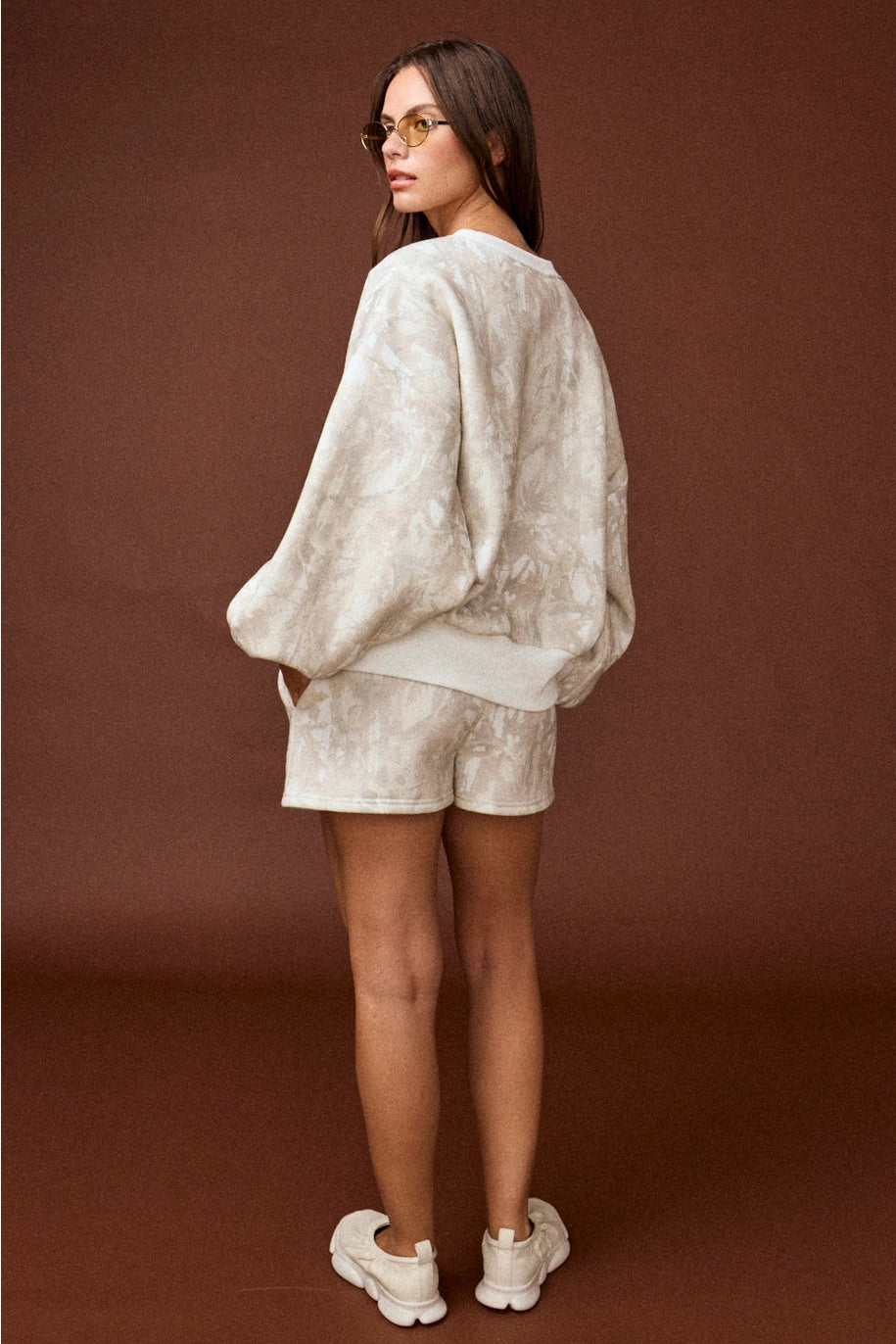 Woodland camo oversized crewneck sweatshirt, part of a matching camo sweat set with coordinating shorts.”