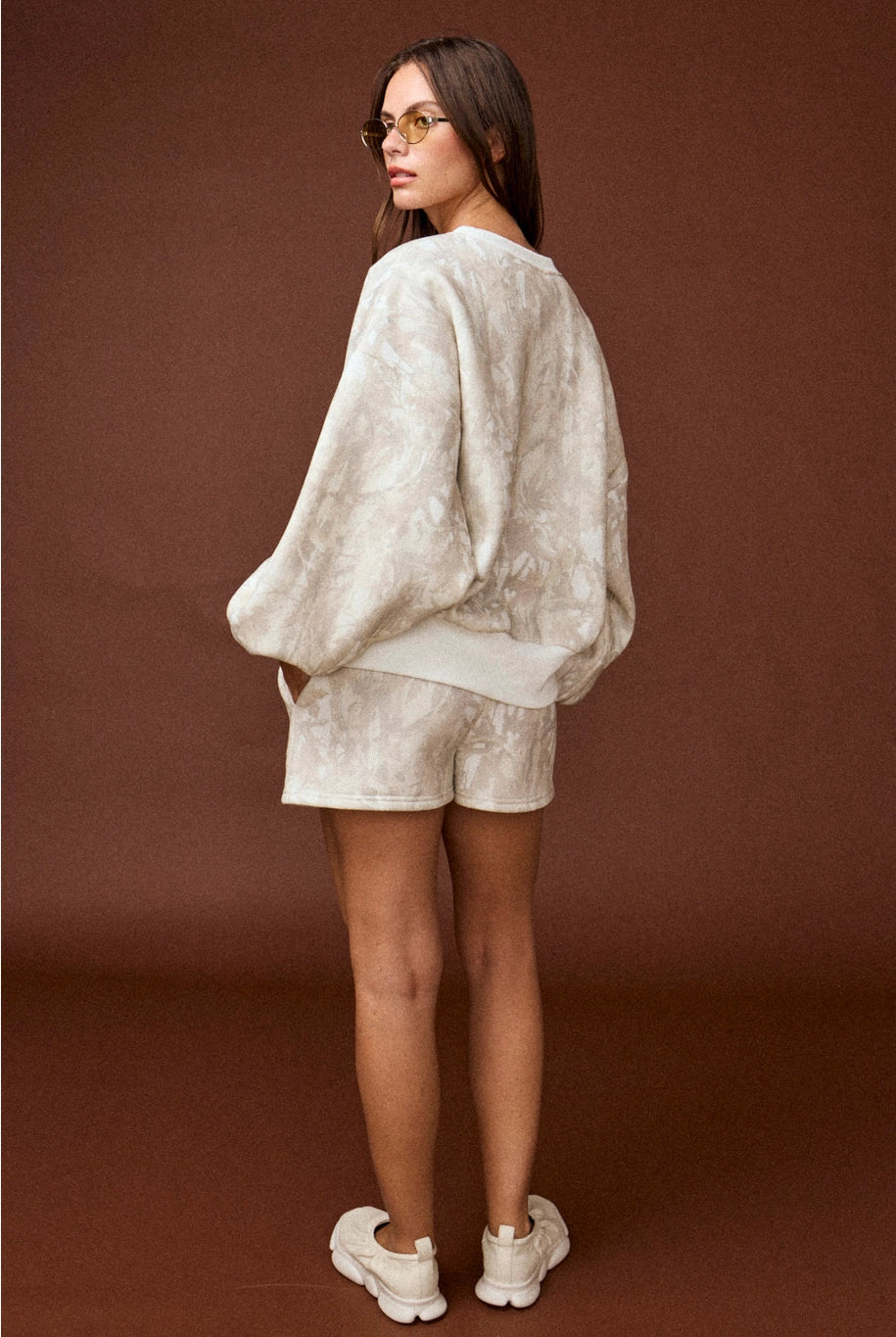 Camo high-waisted drawstring shorts, part of a coordinated camo sweat set with a matching crewneck