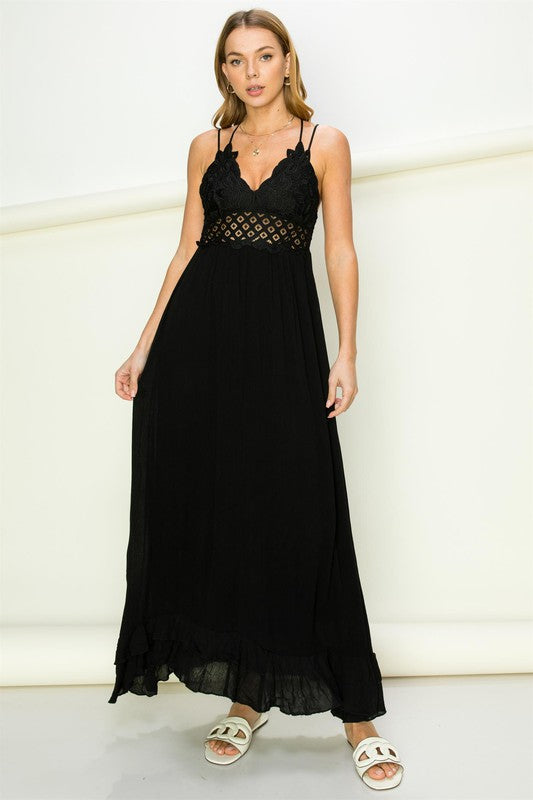 Model wearing an elegant lace maxi dress with a bustier-style bodice and flowing skirt, styled for a romantic formal occasion.