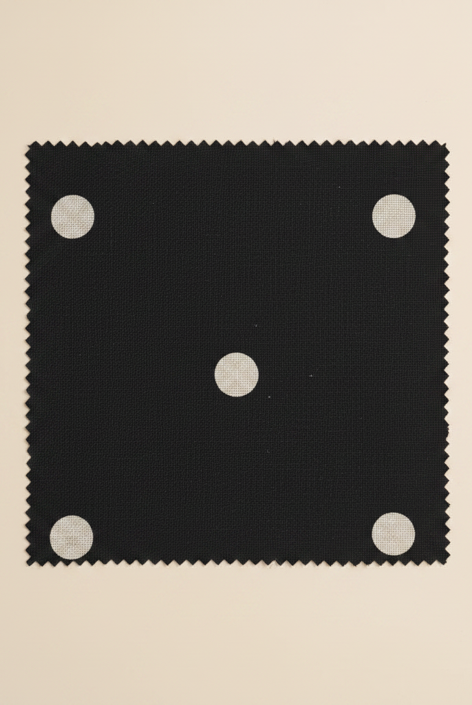 Black fabric with white polka dots flat lay swatch