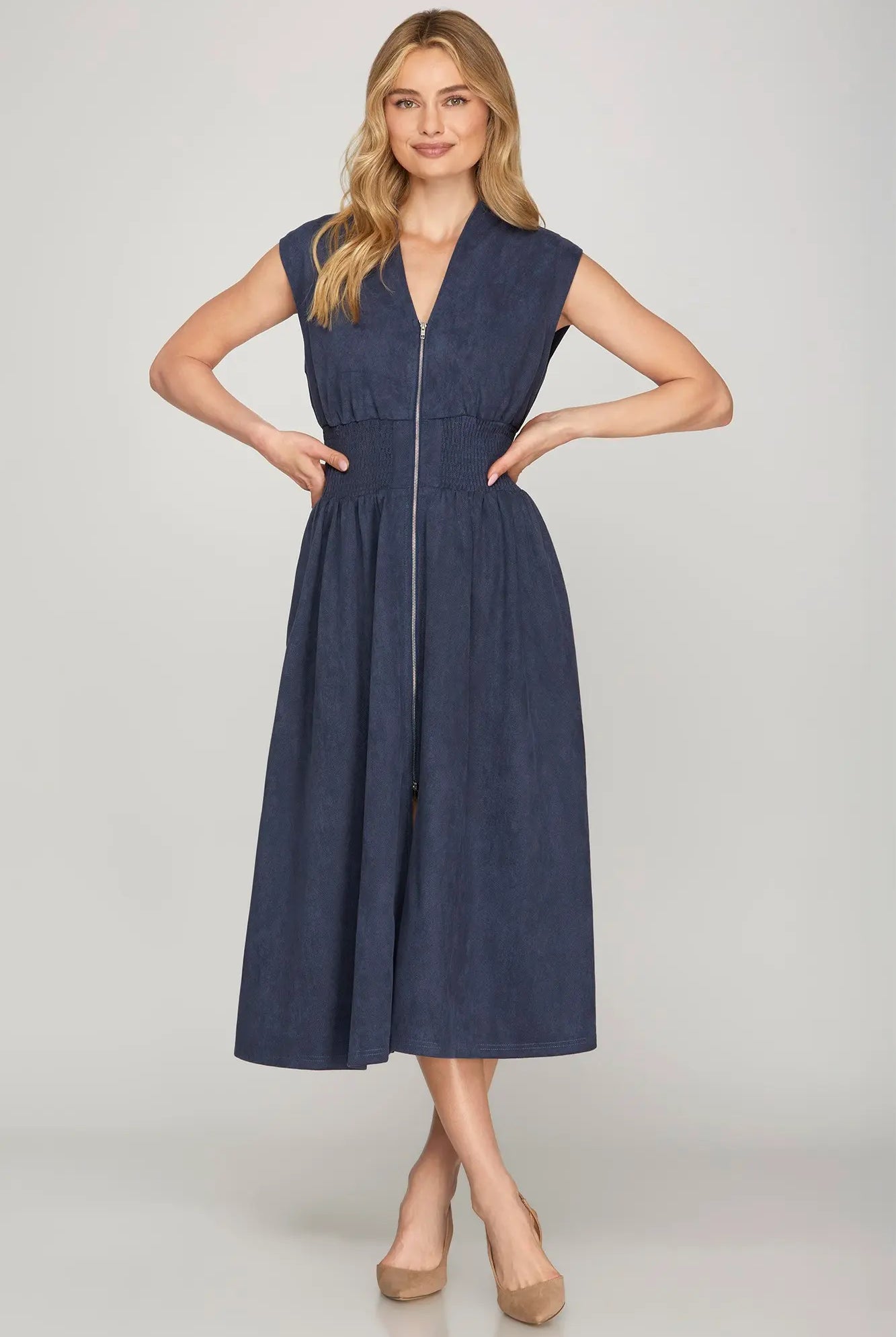Women's midi dress in soft suede fabric featuring a front zipper, flattering smocked waistband, cap sleeves, V-neckline, and side pockets, ideal for modern fall fashion and transitional wardrobes.