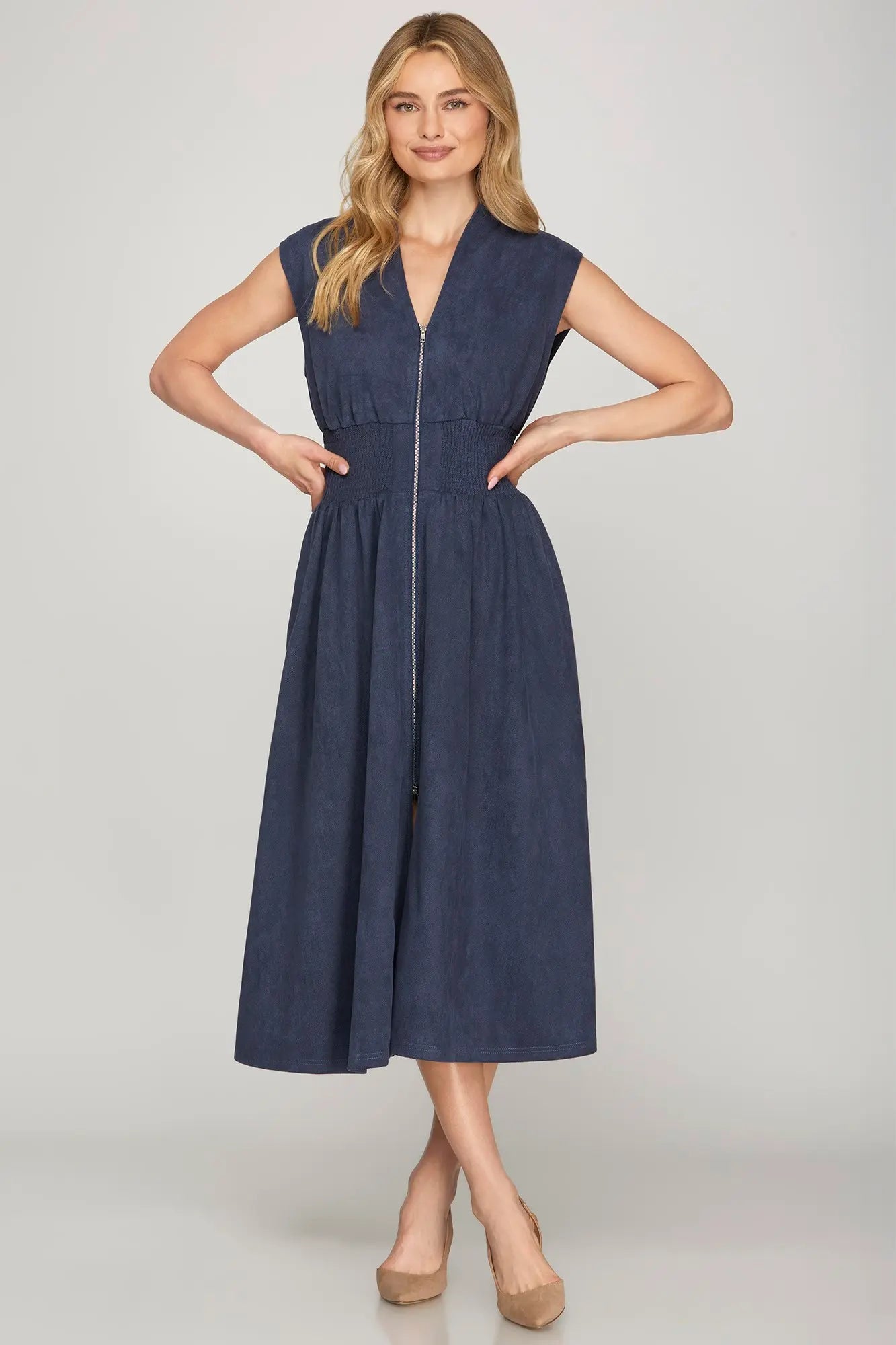 Women's midi dress in soft suede fabric featuring a front zipper, flattering smocked waistband, cap sleeves, V-neckline, and side pockets, ideal for modern fall fashion and transitional wardrobes.