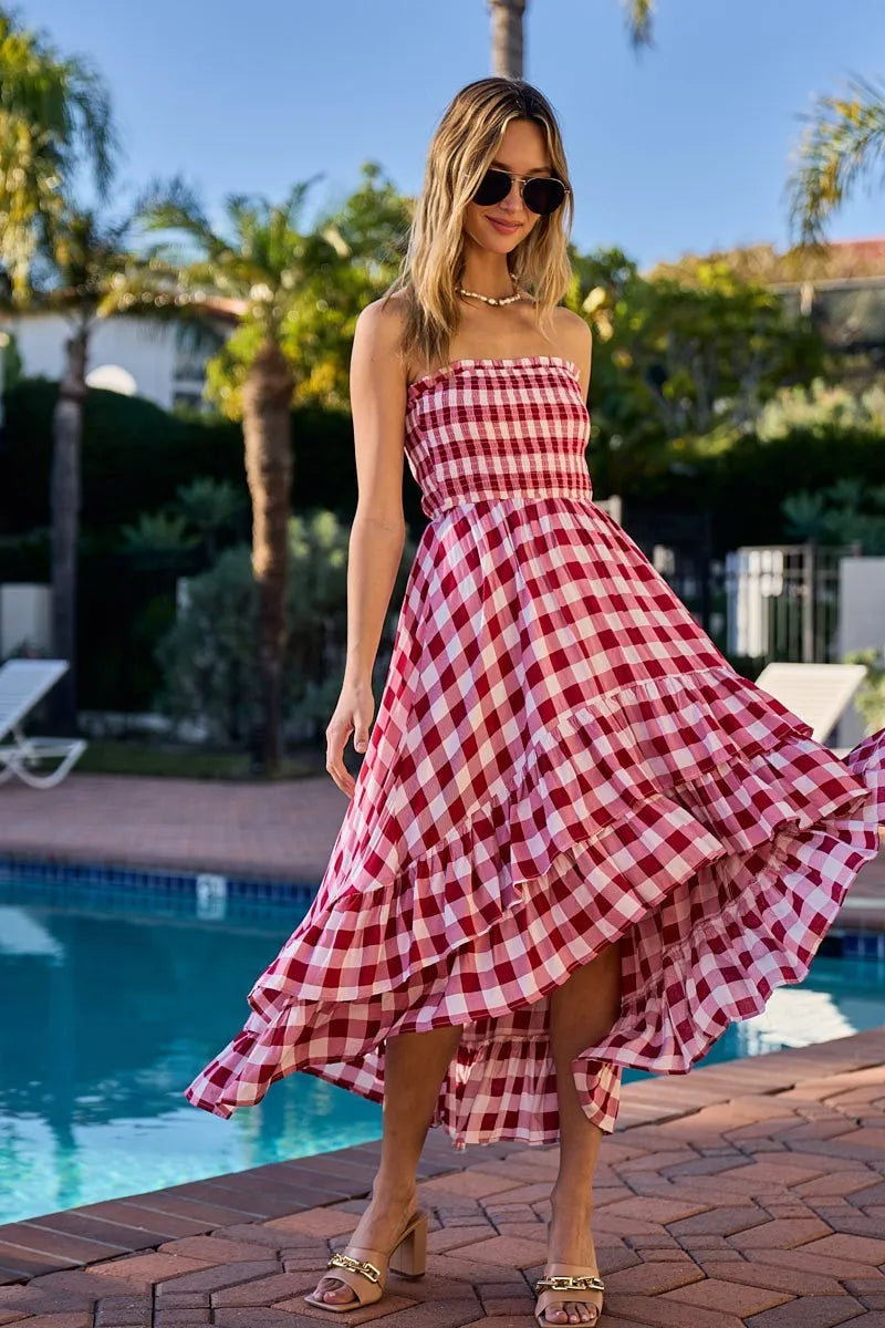 Woman wearing an off-shoulder gingham smocked dress with a flowy silhouette, perfect for casual summer outings, brunch, or vacation wear