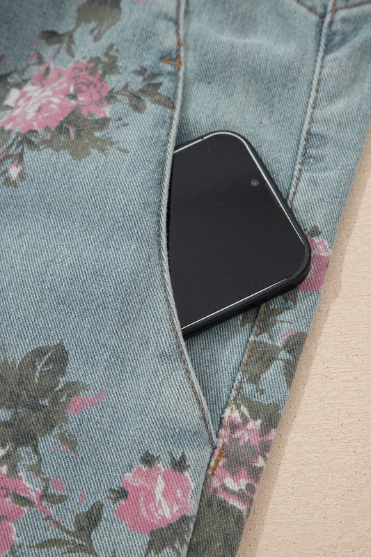 Pink and sage floral print denim overalls from Thread Bar Boutique with pleated detailing and relaxed wide leg silhouette.