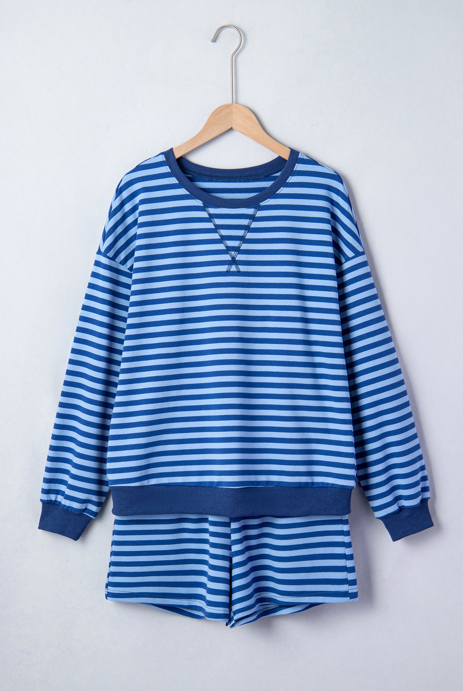 Blue striped lounge short set from Thread Bar Boutique with breathable cotton blend, long sleeve top, and pull-on shorts flat lay front