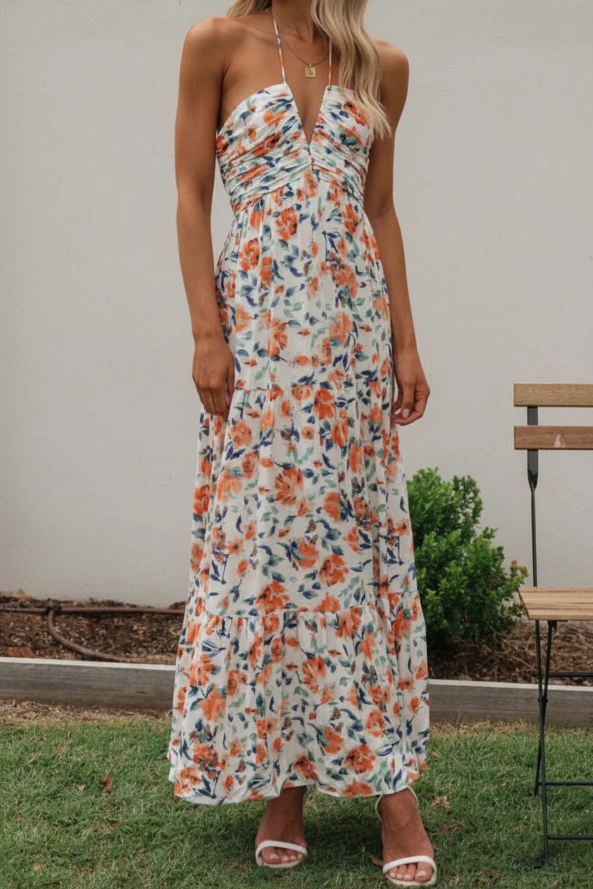 Floral halter midi dress from Thread Bar Boutique featuring ruched front, open tie back, and flowy feminine silhouette