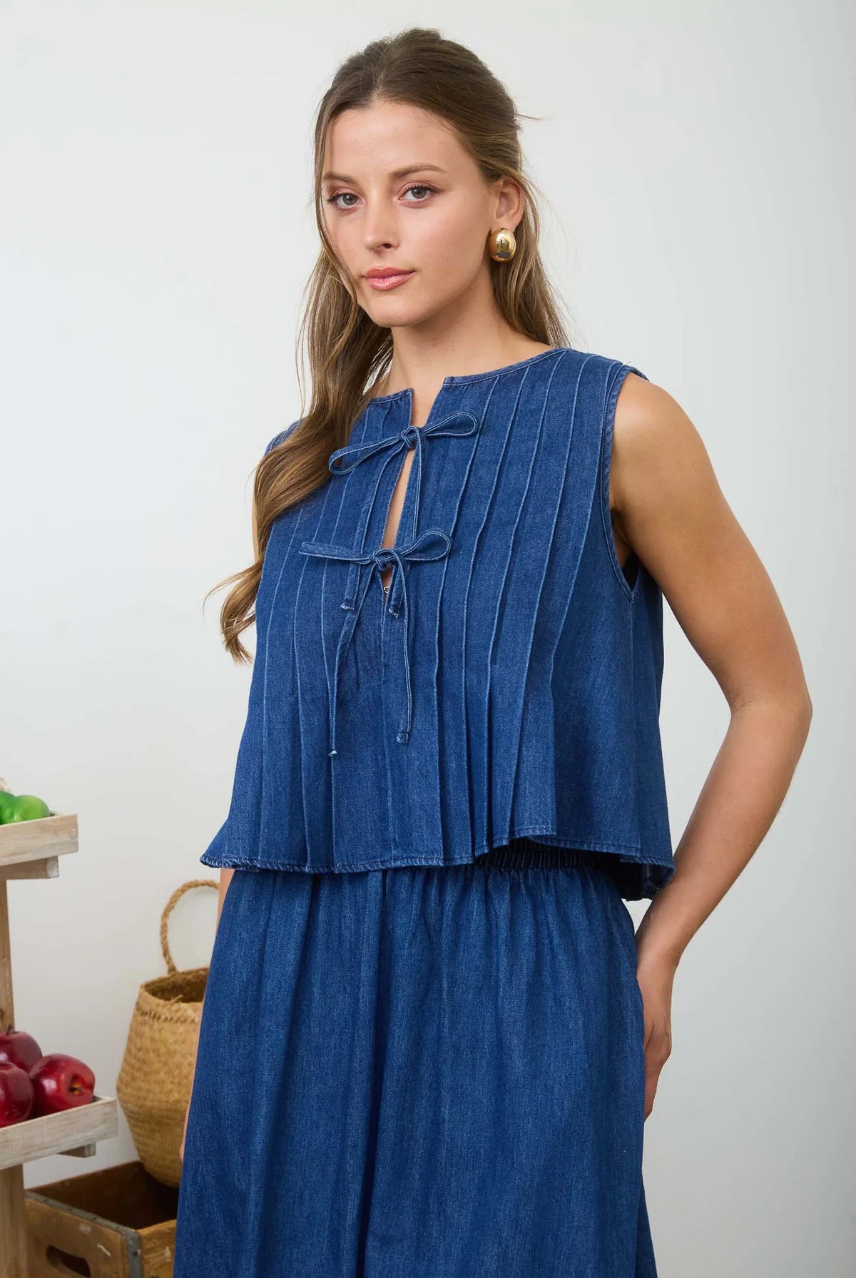woman wearing a denim top and skirt set top tie front and skirt has pockets