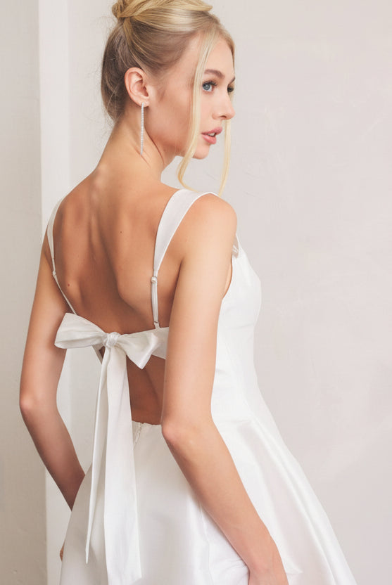 Classic white mini skater dress with square neckline and tie back closure