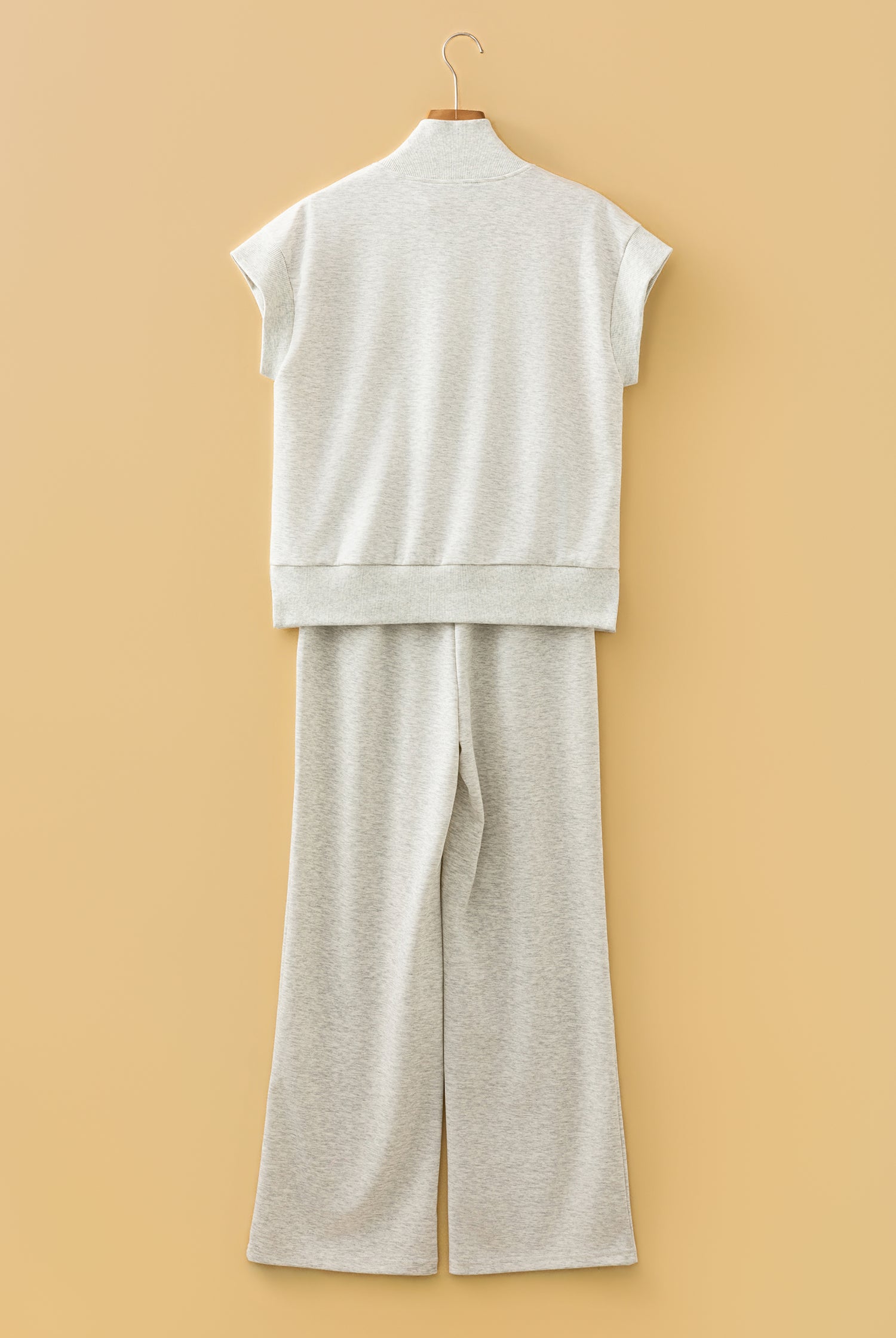 Rear View of flat lay of grey half zip polo tee and coordinating pants set