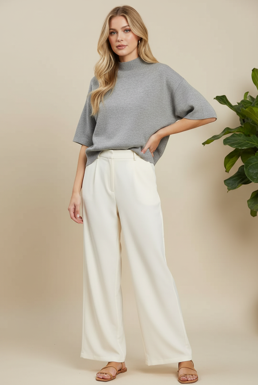 Heather grey mock neck short sleeve knit sweater top with ribbed hem styled with wide-leg cream trousers and strappy sandals, women's boutique knit top at Thread Bar Boutique