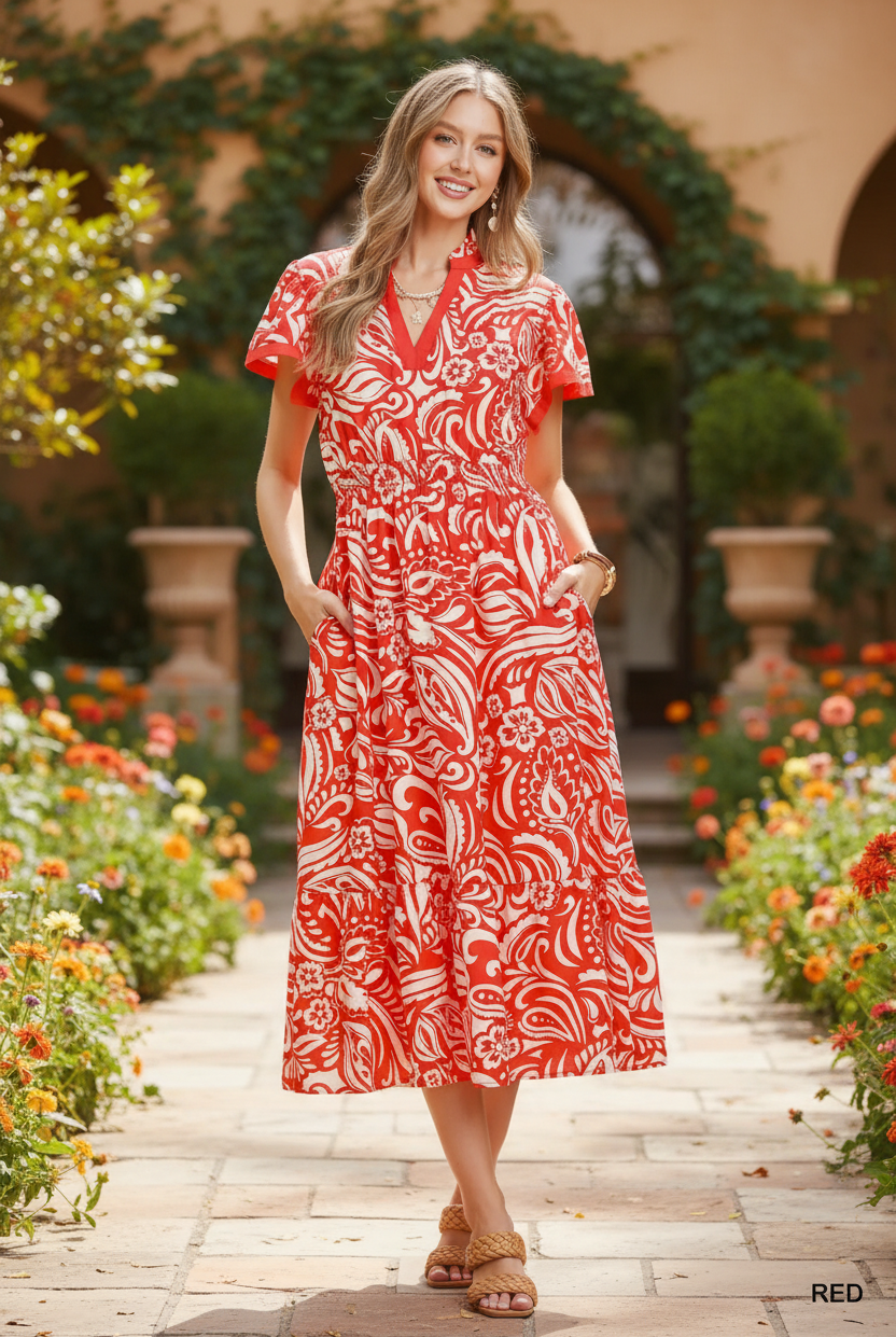 Red and cream bold paisley floral midi dress with pockets full body front view, hands in pockets, flutter sleeves, smocked waist, ruffle hem, outdoor lifestyle
