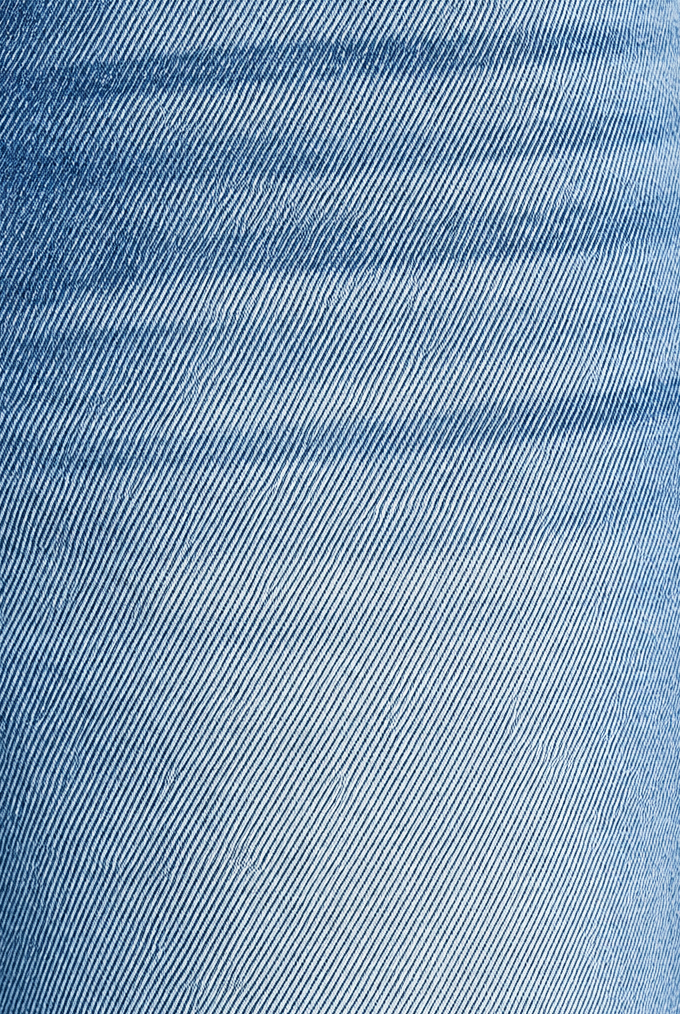 Close-up of medium wash denim showing fabric weave, faded finish and front pocket stitching on barrel jeans