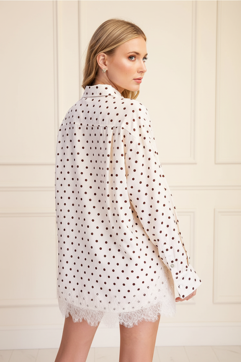 Ivory polka dot lace trim oversized shirt back view showing lace hem trim detail, blonde model, batten and board wall background