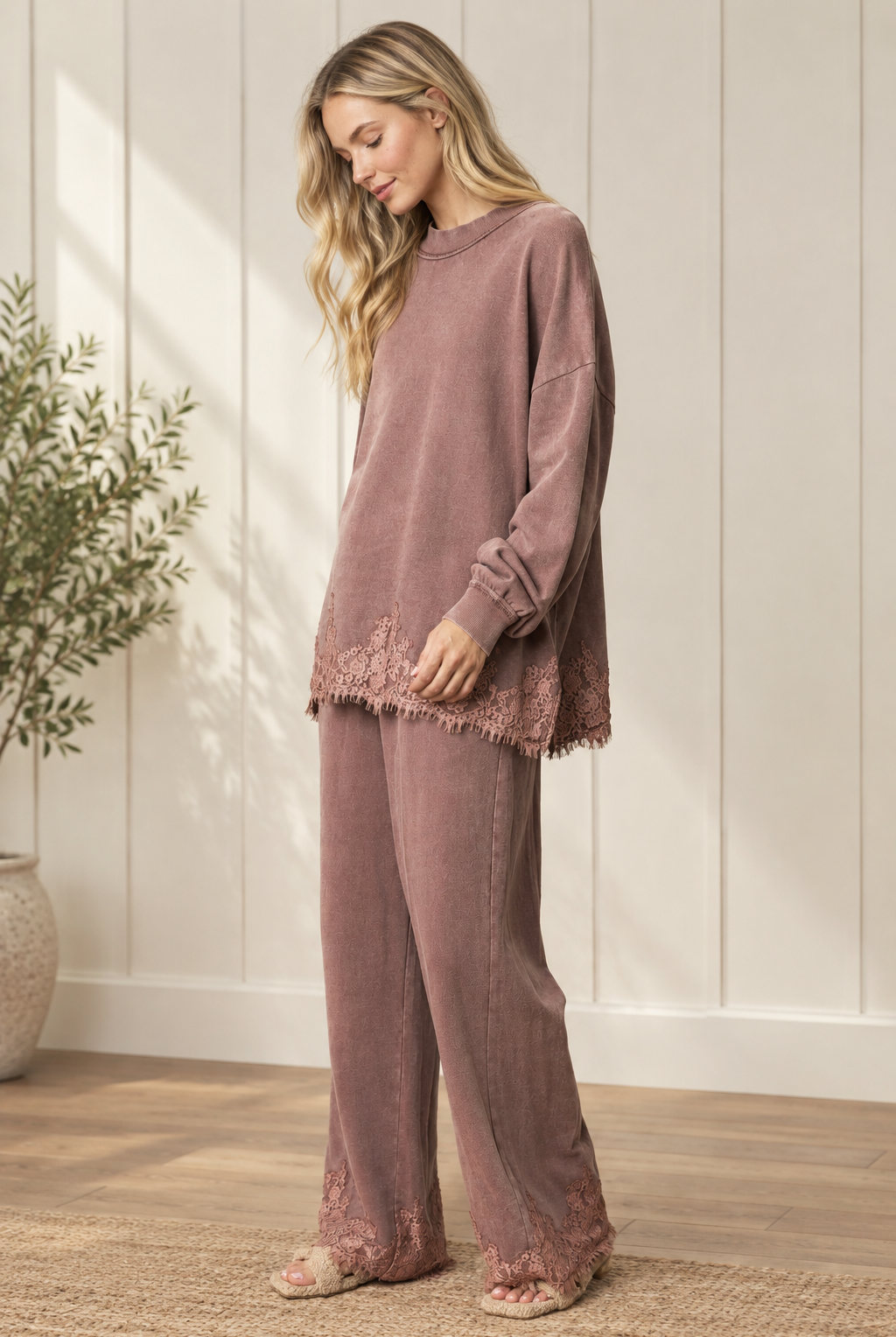Mauve-brown French terry track pants with wide legs and floral lace hems, worn with the coordinating sweatshirt.