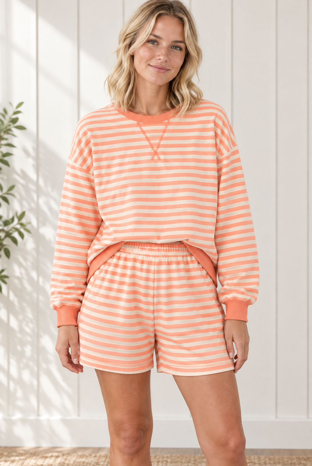 Front view of Grapefruit Orange striped lounge set with relaxed long sleeve pullover and matching elastic-waist shorts