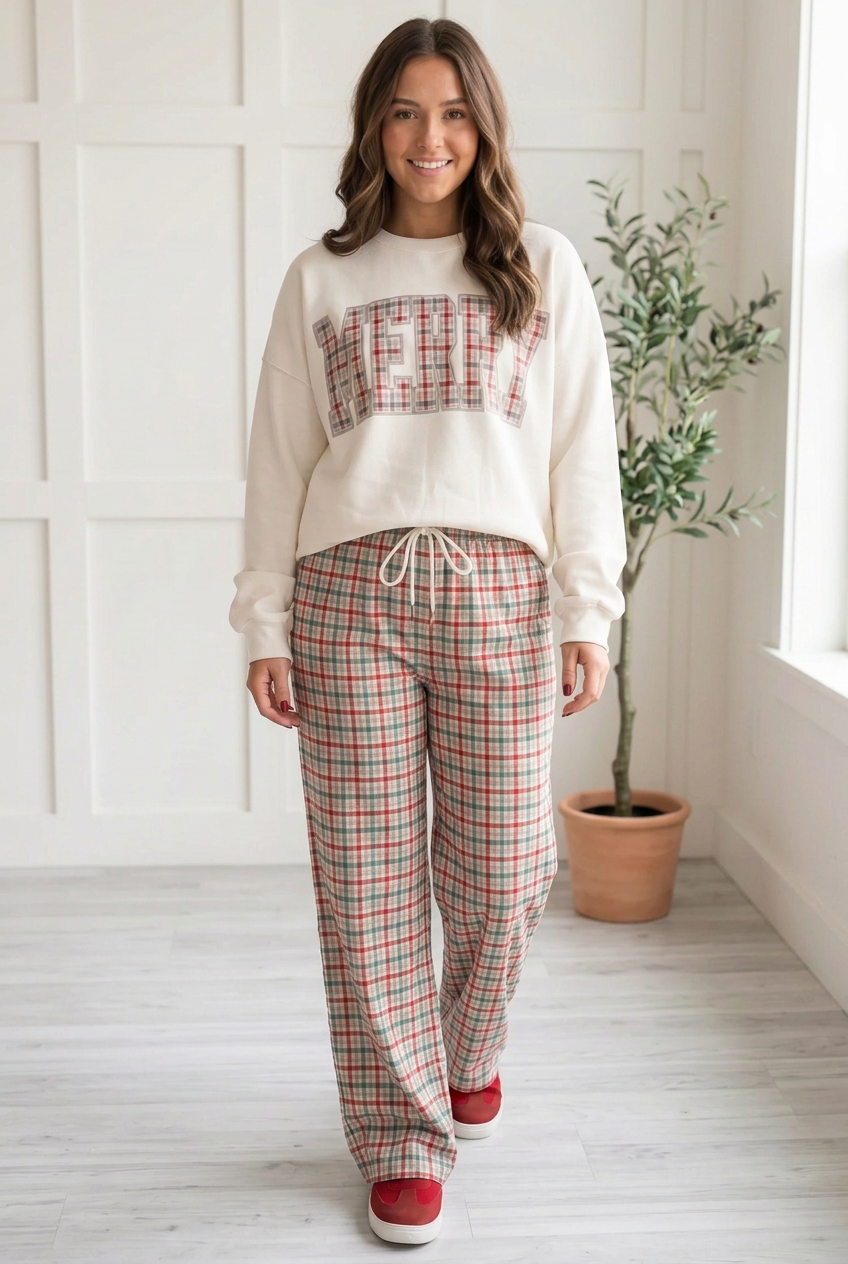 Cream, grey and red plaid drawstring pants in a walking pose showing the relaxed wide legs and full length drape.