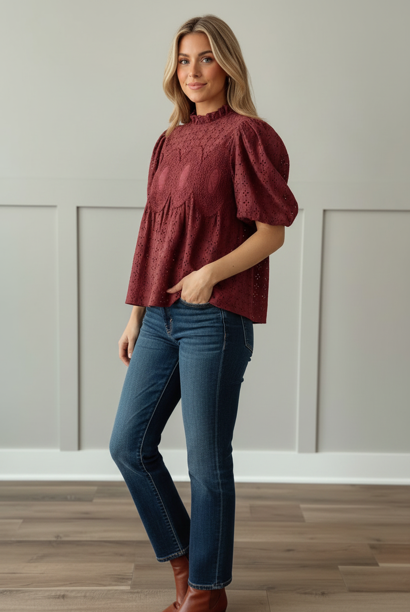 Cranberry eyelet puff sleeve blouse with ruffled mock neck and crochet medallion bodice detail, three-quarter angle view showing relaxed babydoll silhouette