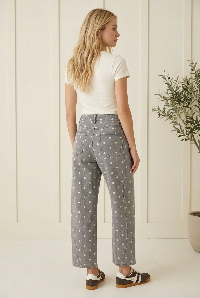 Back view of charcoal polka dot barrel jeans showing rear patch pockets, belt loops and cropped hems.