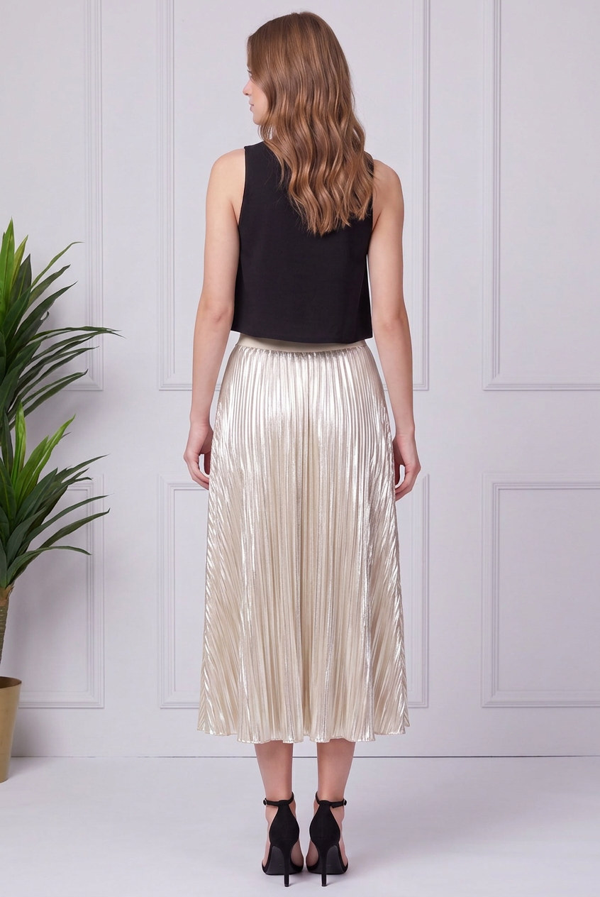 Back view of cream silver metallic pleated midi skirt with an elastic waistband and mid-calf hem.