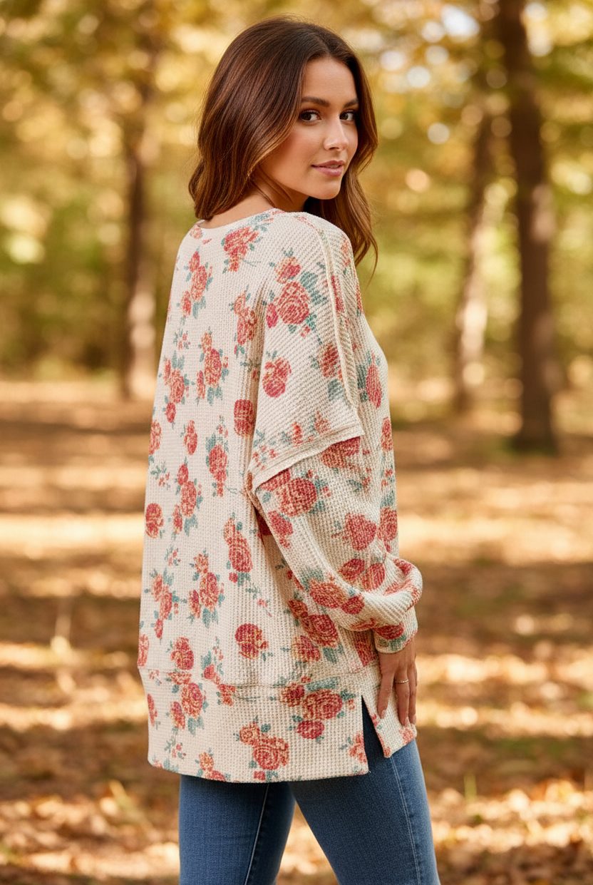 Oatmeal floral print oversized waffle knit sweatshirt back three-quarter view showing exposed seam detail and dramatic balloon sleeves, styled with denim jeans