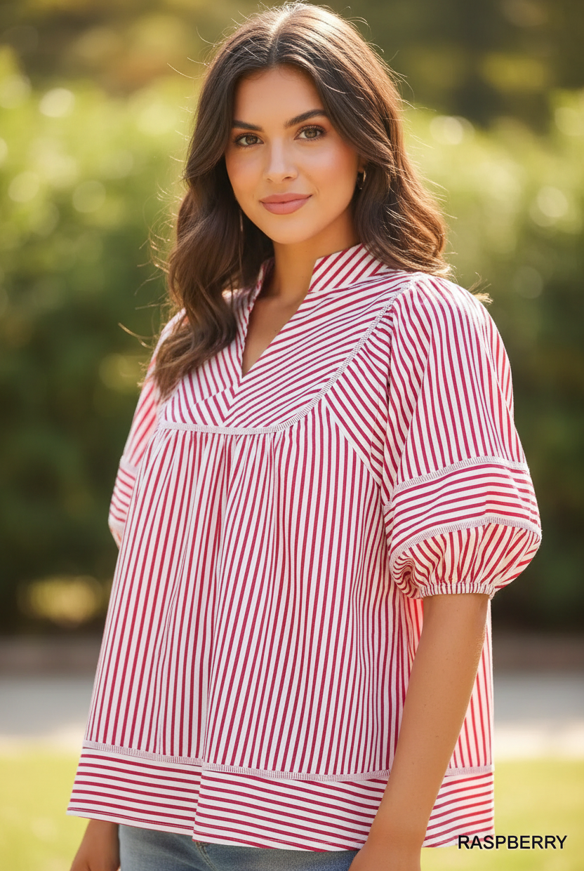 Close-up detail of Umgee raspberry striped puff sleeve babydoll top showing V-notch collar, contrast trim yoke seam, and elasticated puff sleeves