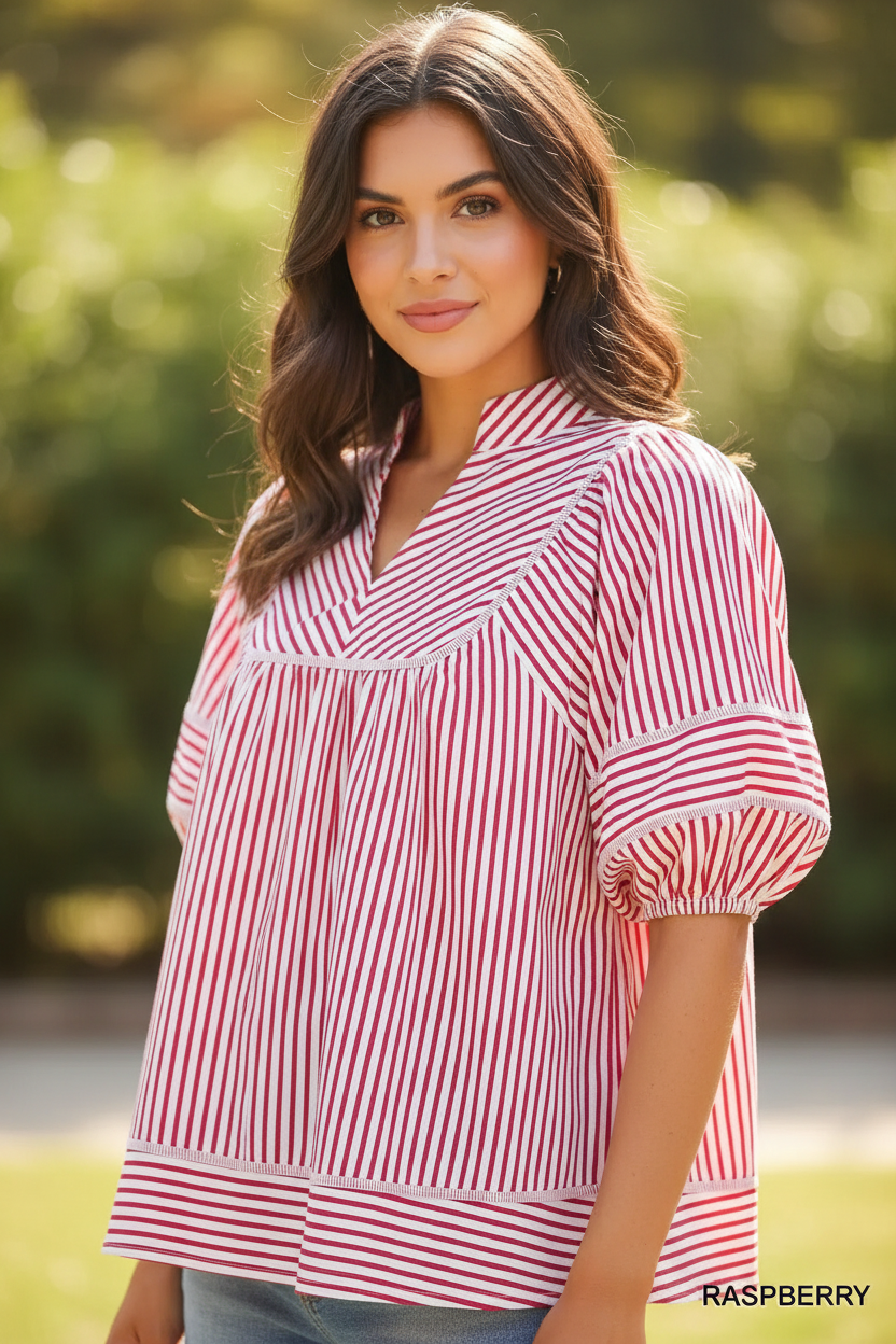 Close-up detail of Umgee raspberry striped puff sleeve babydoll top showing V-notch collar, contrast trim yoke seam, and elasticated puff sleeves
